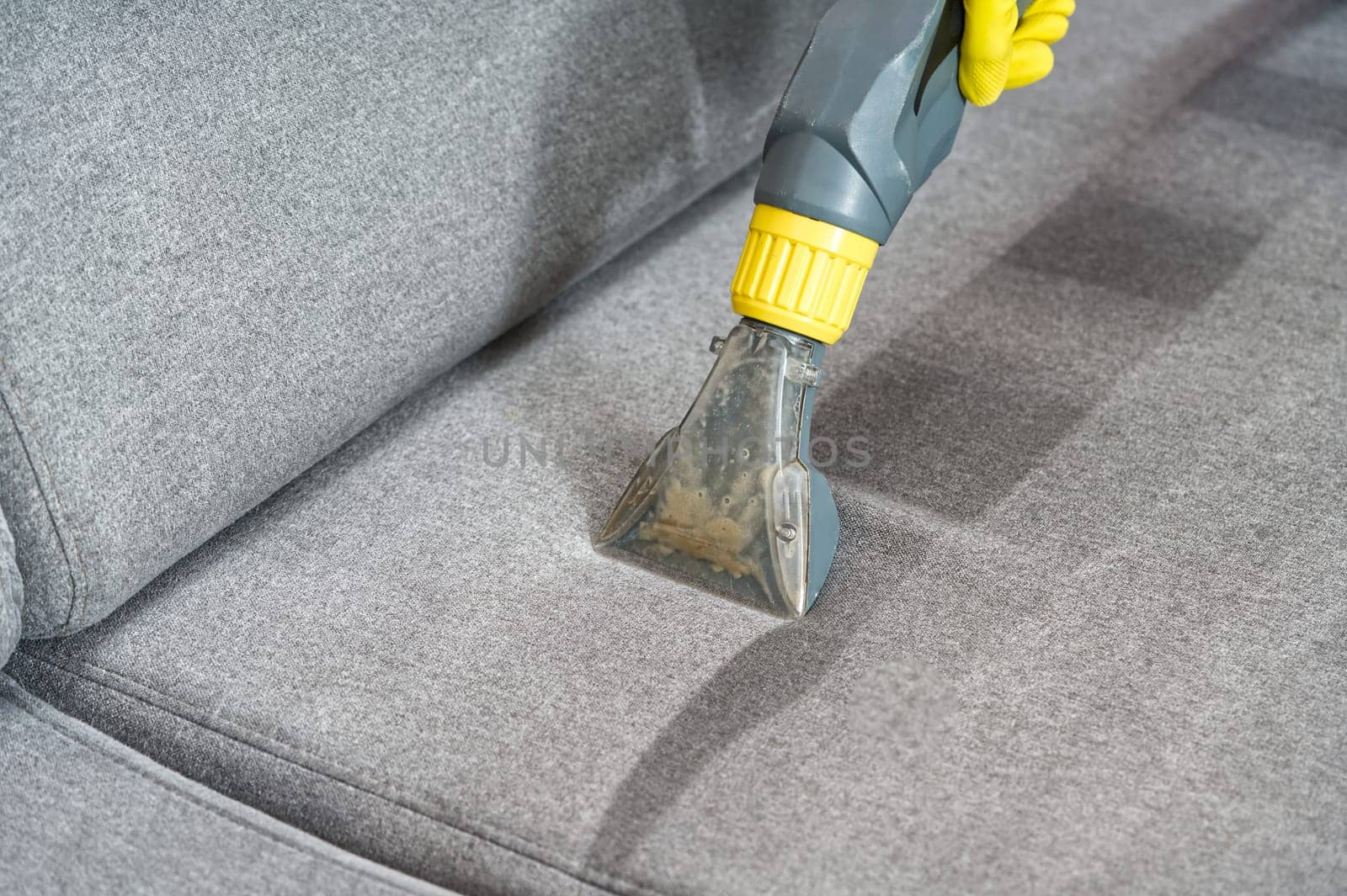 Sofa chemical cleaning with professionally extraction method. Wet textile sofa cleaning by PhotoTime