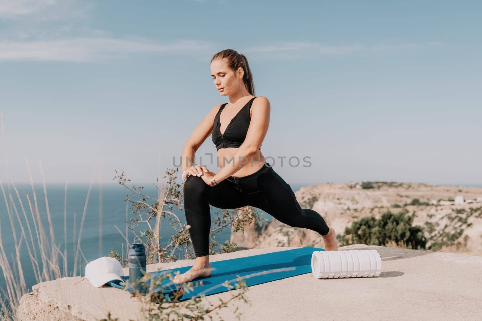 Fitness woman sea. Outdoor workout with fitness rubber bands in park over beach. Female fitness pilates yoga routine concept. Healthy lifestyle. Happy fit woman exercising with rubber band in park