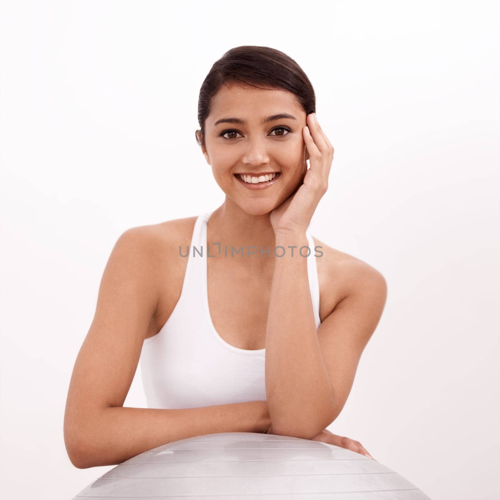 This ball is great for pilates. Portrait of a young woman sitting with a pilates ball