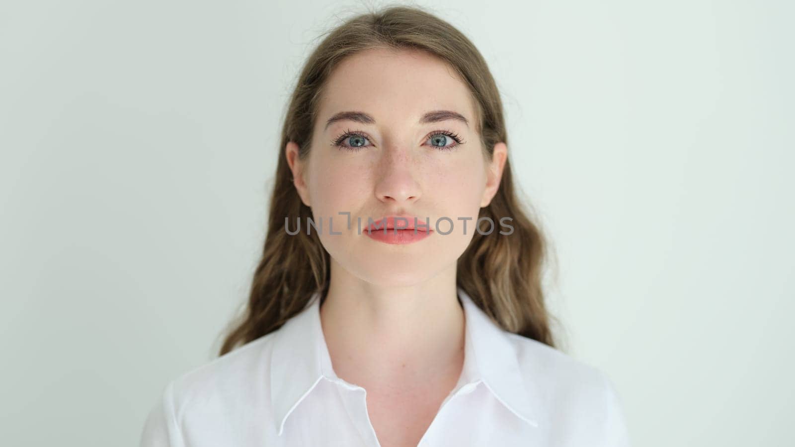 Portrait of young beautiful woman in white shirt . Healthy facial skin concept