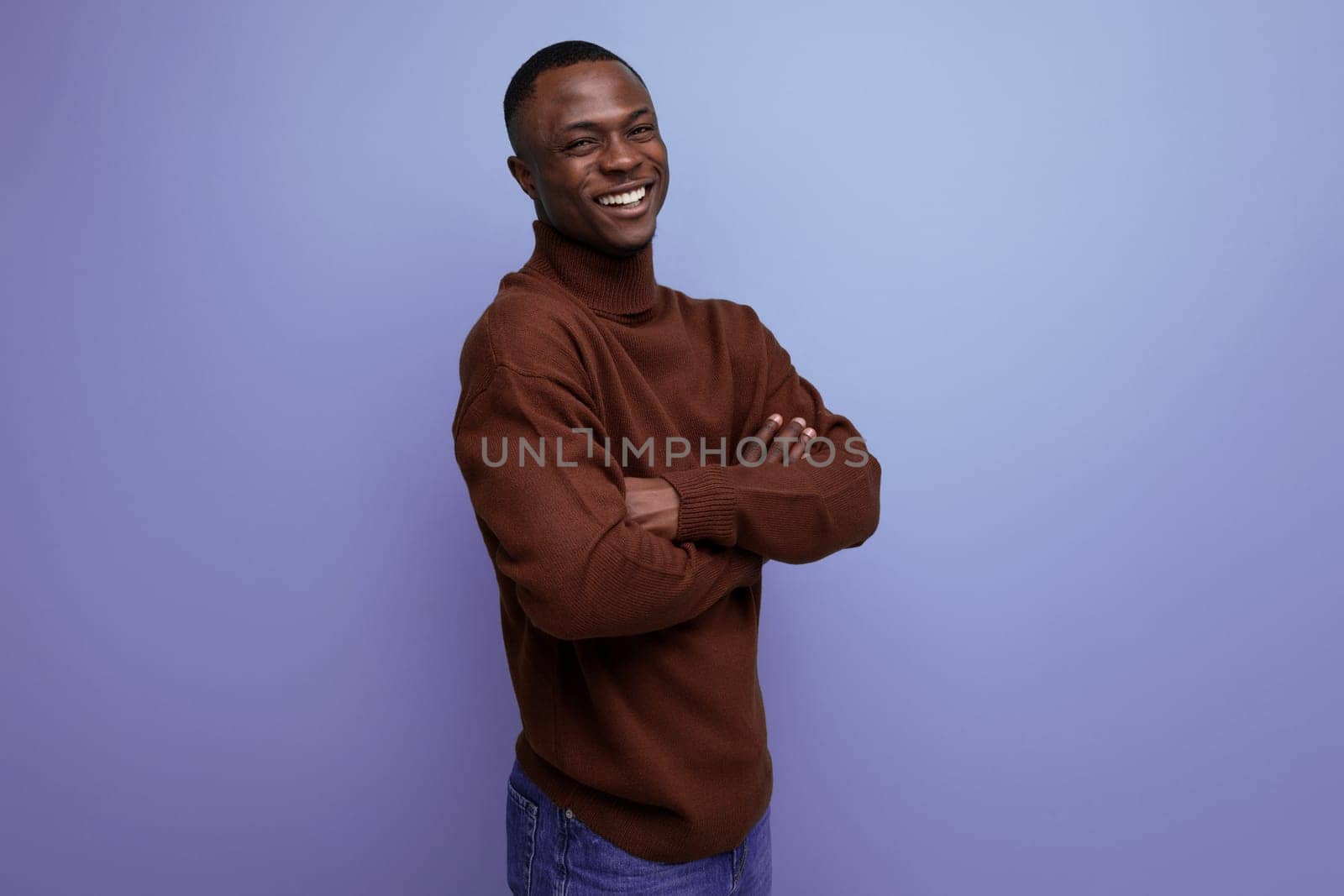 positive young ethnic african businessman in studio background.