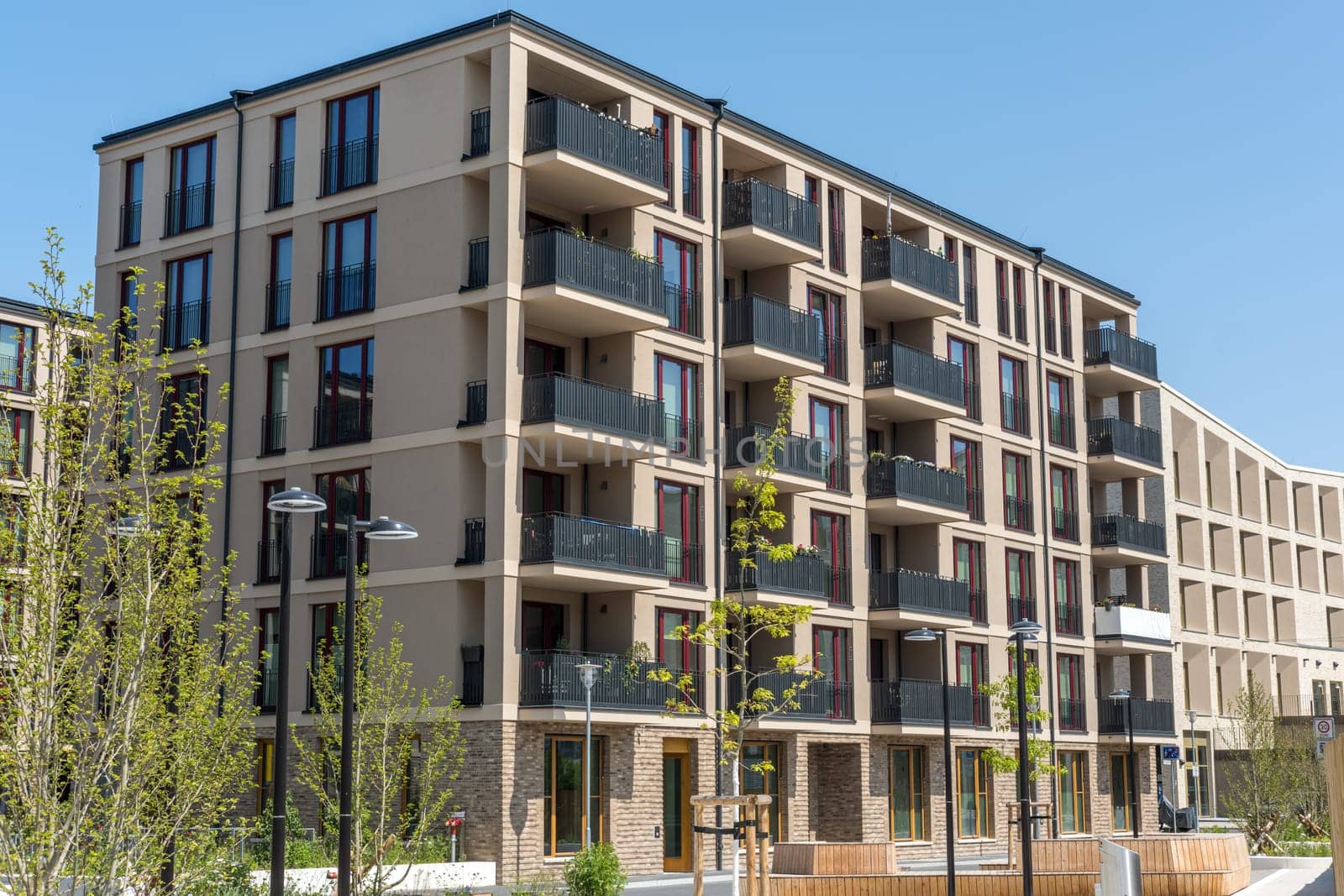 Modern brown apartment buildings in a housing development area by elxeneize