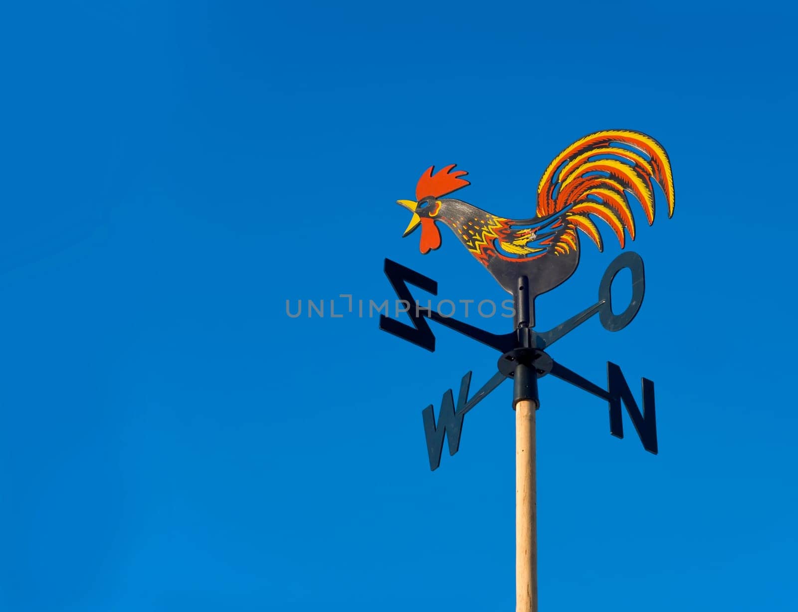 wind vane to indicate the wind direction and the metal cock above the arrow and cardinal points North East South West.