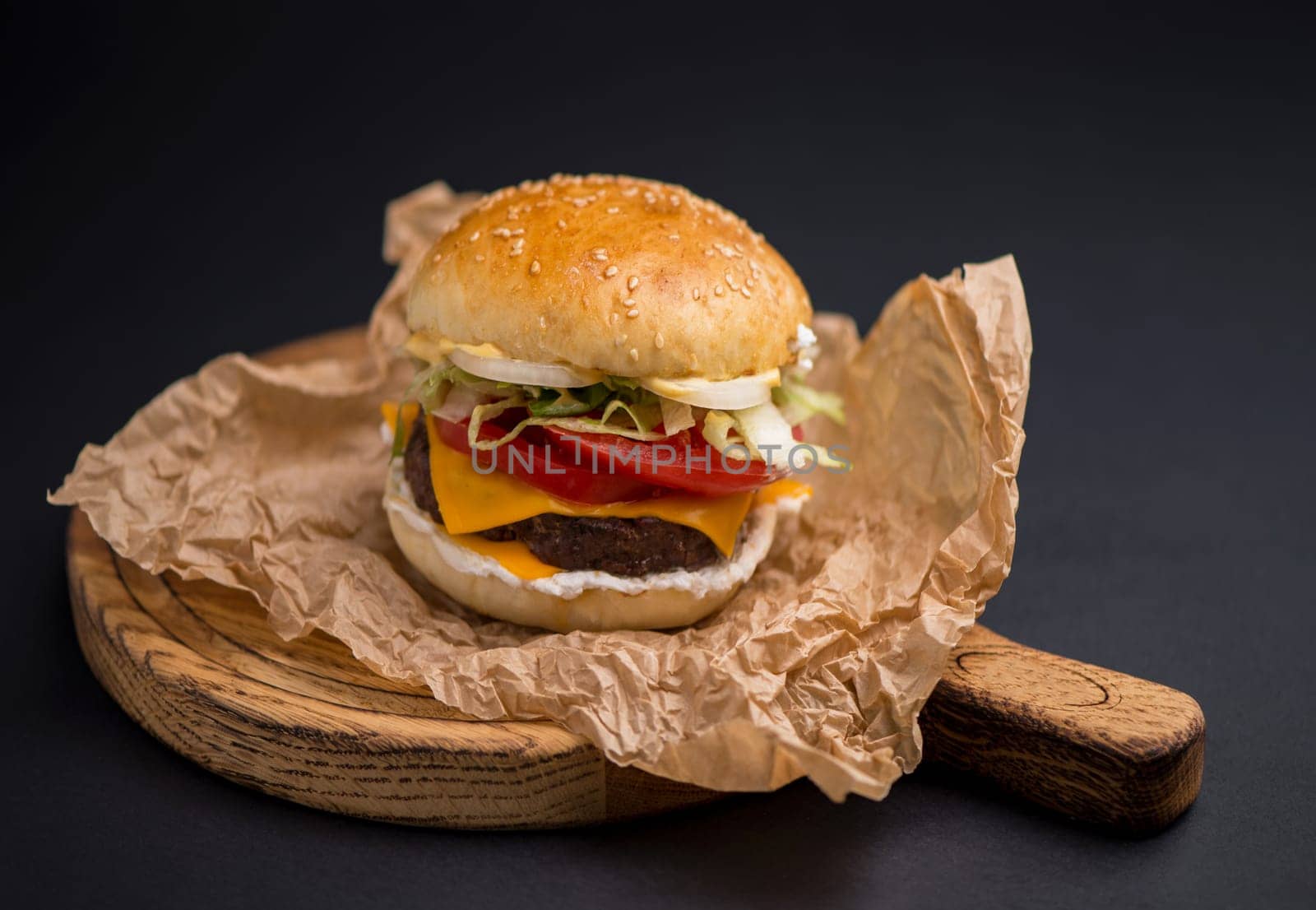 Big tasty burger with beef cutlet on a black