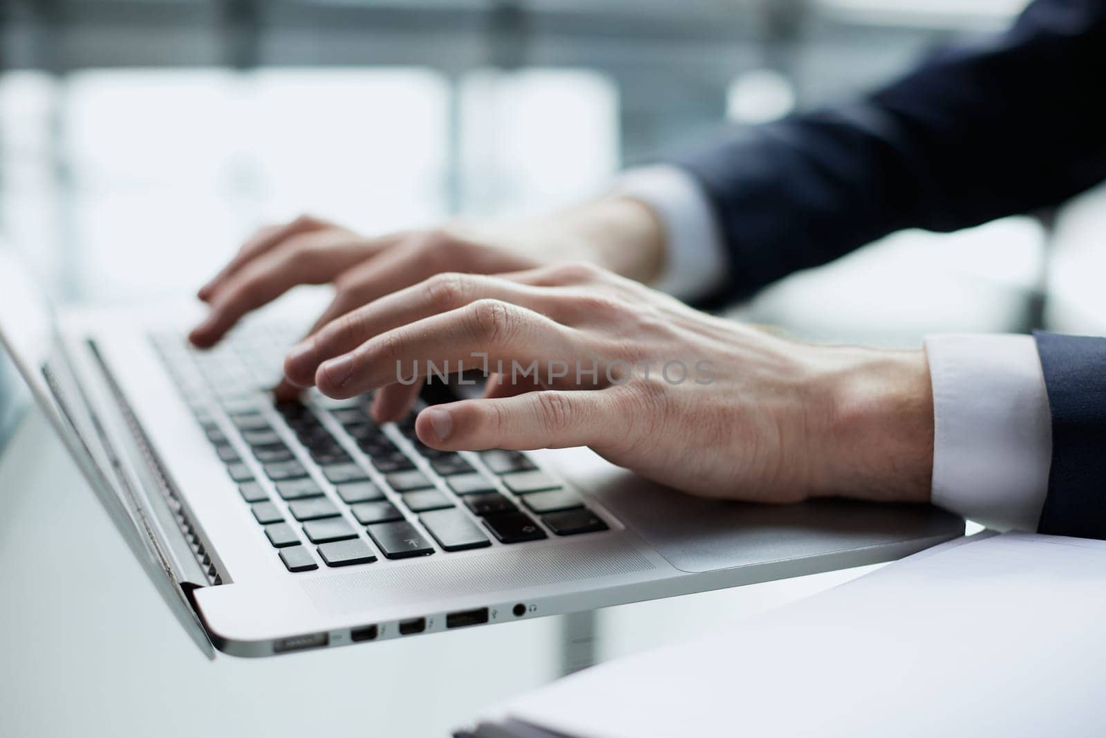 Young man working on computer at table in office, closeup. Banner design