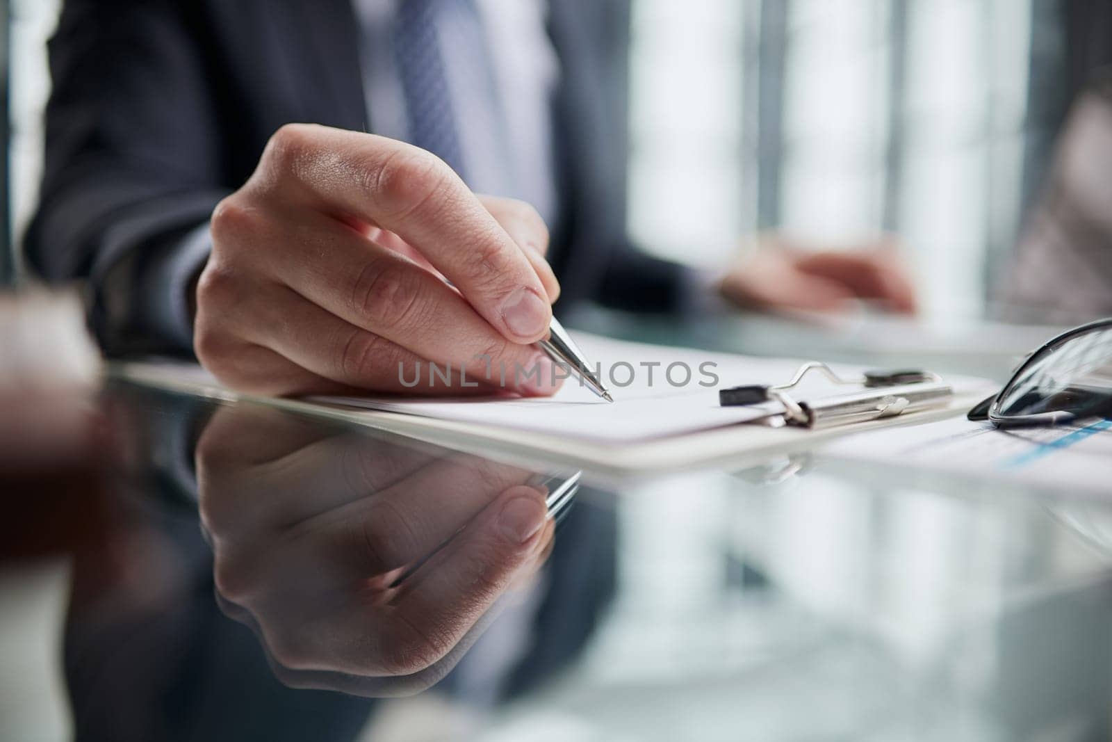 man hands with pen writing on notebook in the office.learning, education and work