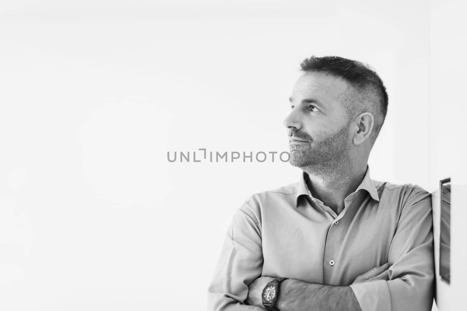 casual older with beard businessman wearing formal business clothes smiling at camera with crossed hands isolated over gray background. High quality photo