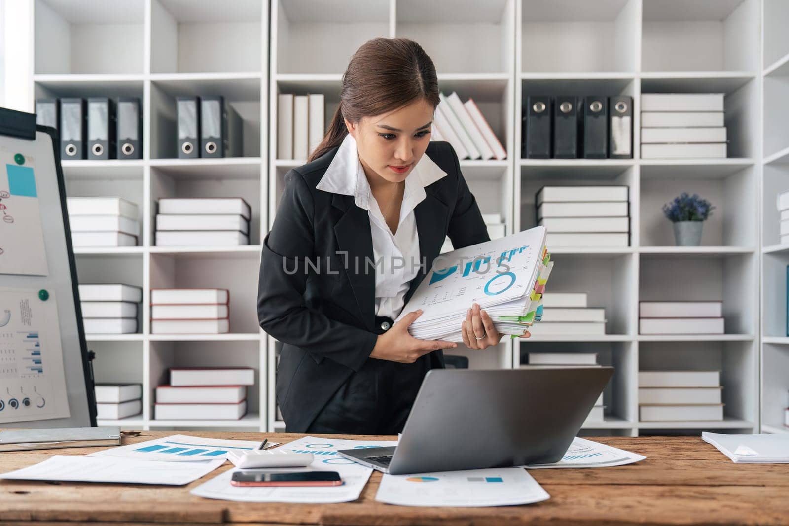 woman hands working in stacks of paper files document achieves on folders papers. copy space.