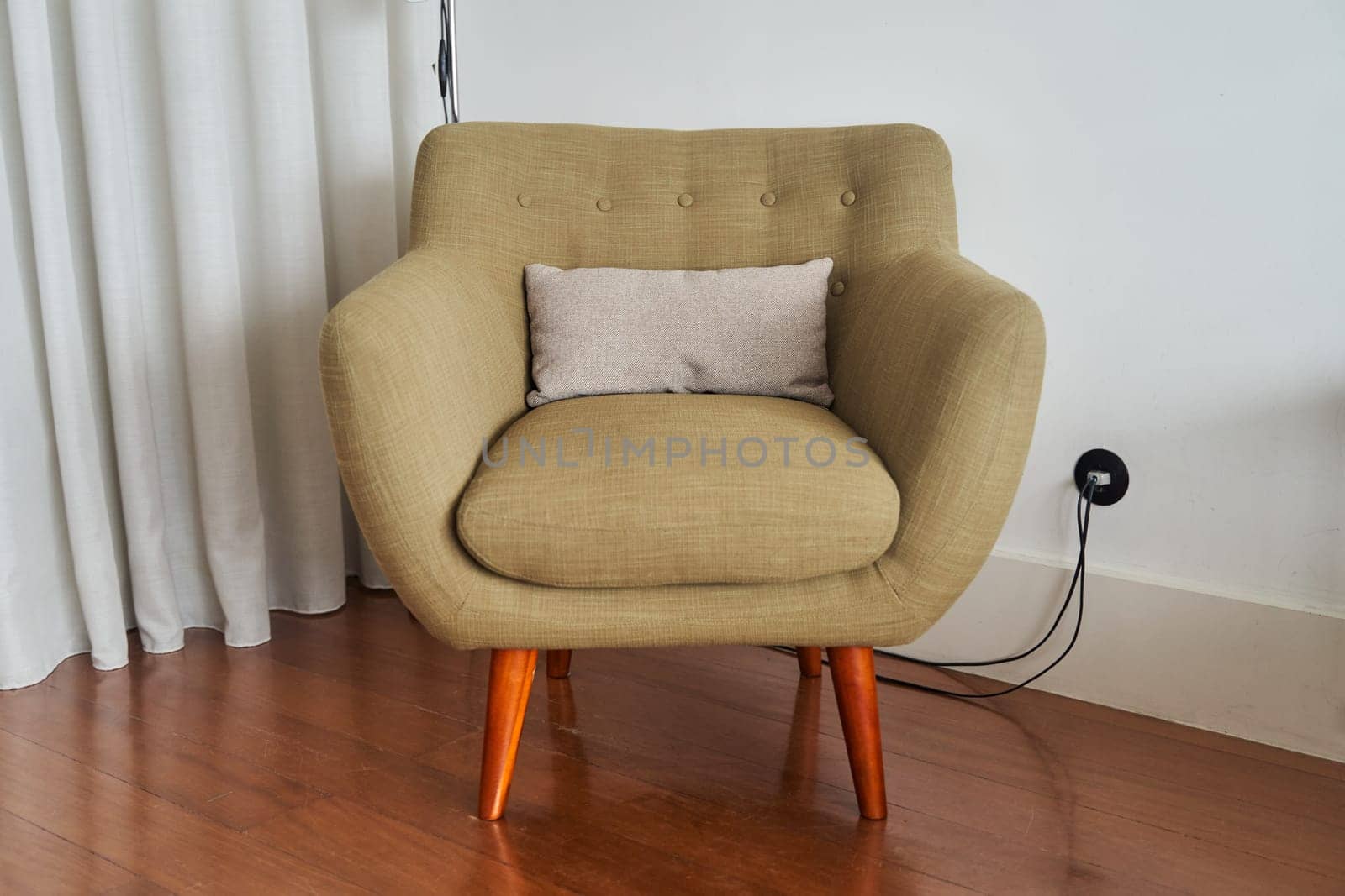 View of stylish green armchair in interior by driver-s
