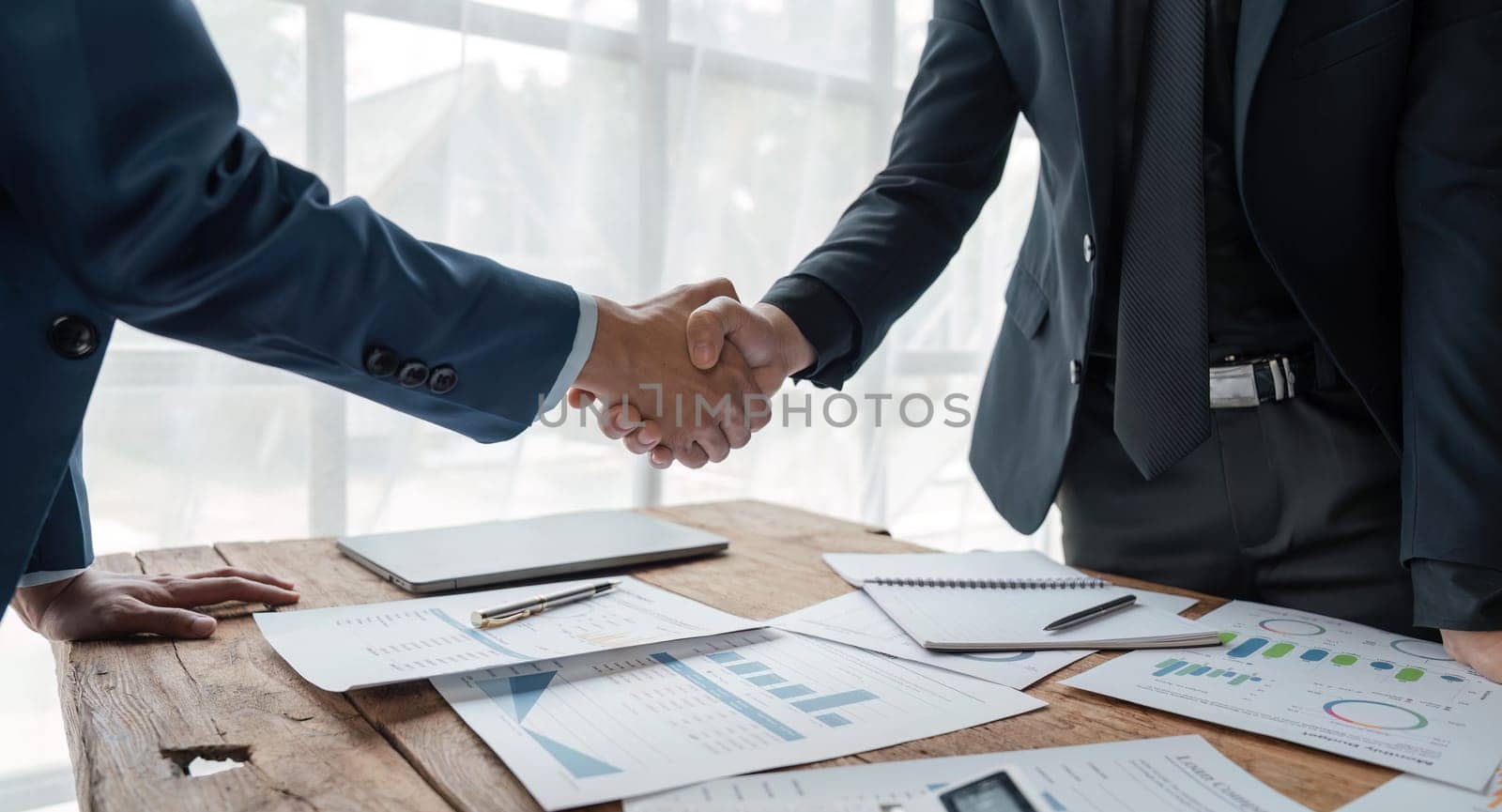 Business handshake for teamwork of business ,successful negotiate, hand shake, two businessman shake hand with partner to celebration partnership and business deal concept.