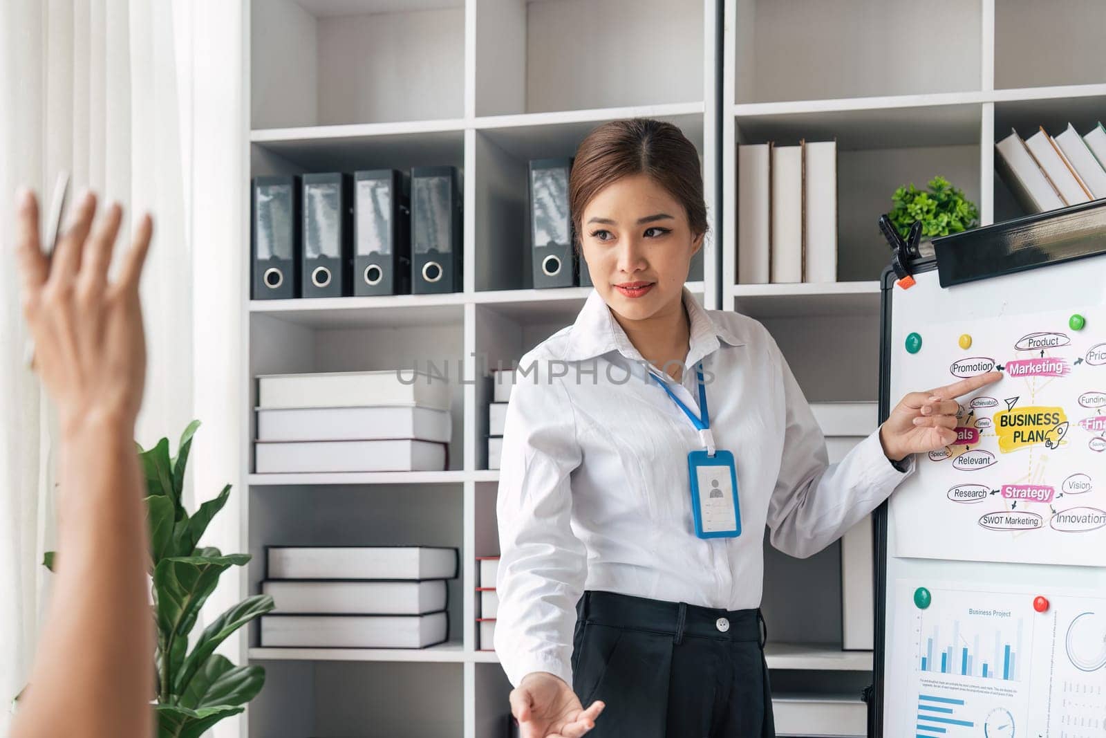 business woman listens to business man that raises a hand with the good comment at a business group meeting, New business plan in the office.