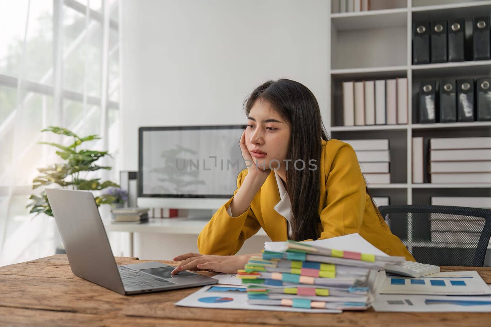 Asian business women are stressed while working on laptop and pile of documents, Tired asian businesswoman with headache at office, feeling sick at work.