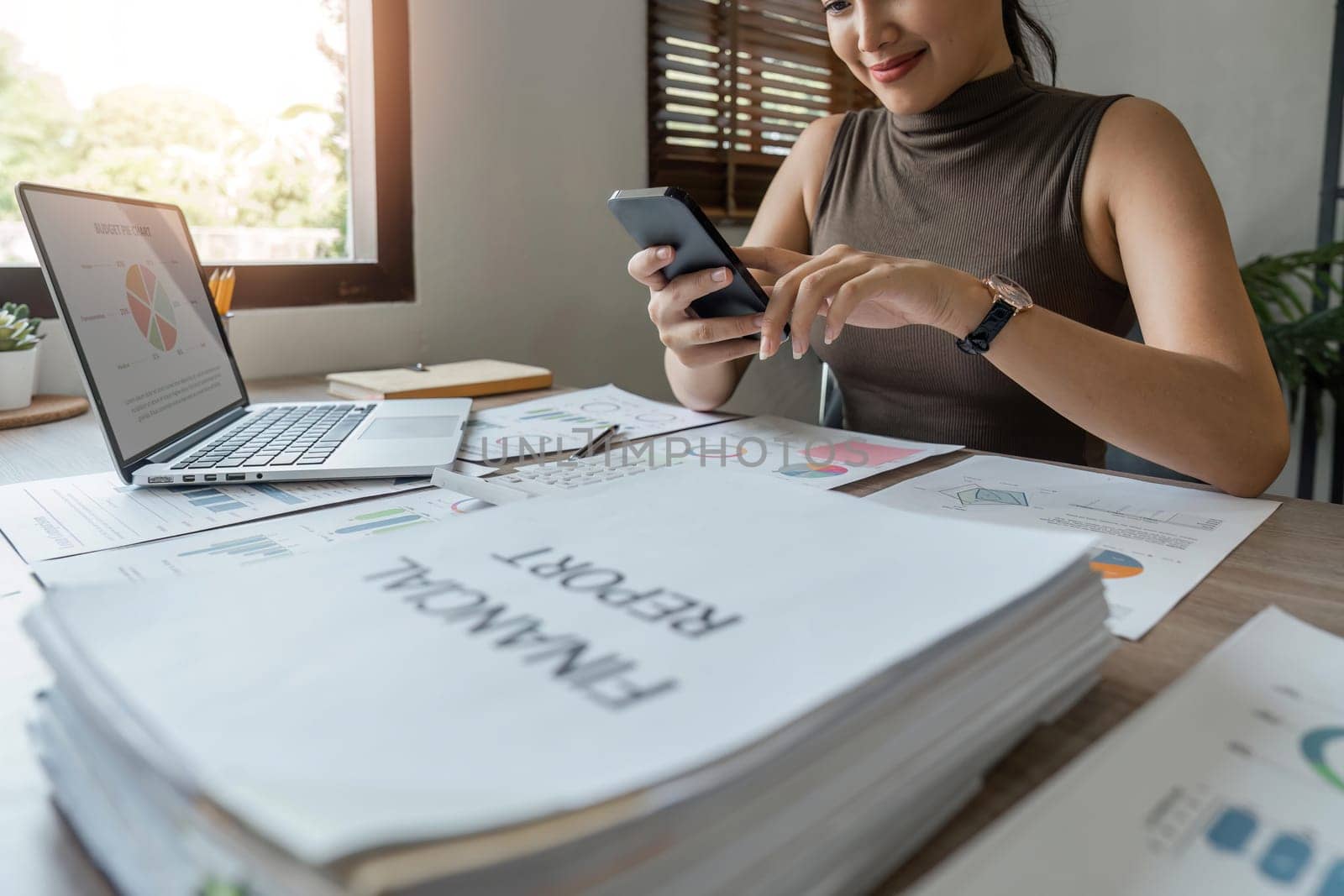 Asian businesswoman in home happy and cheerful during using smartphone and working.