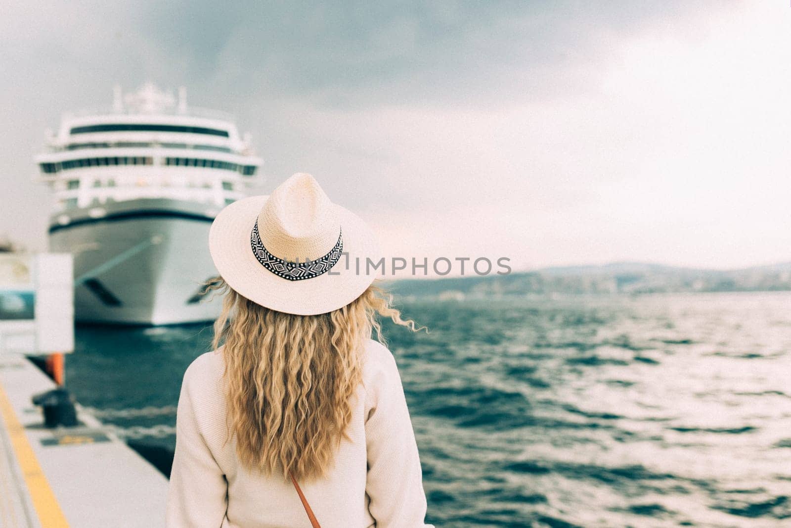 Woman tourist standing in front of big cruise liner, travel female.