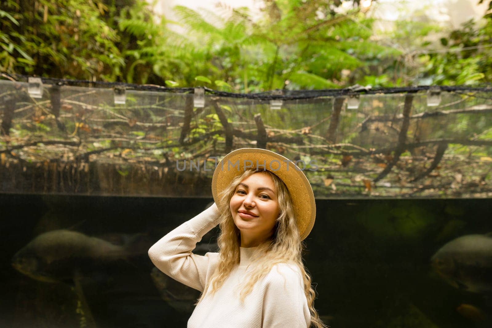 Portrait of a relaxed happy woman in a hat looking at the camera