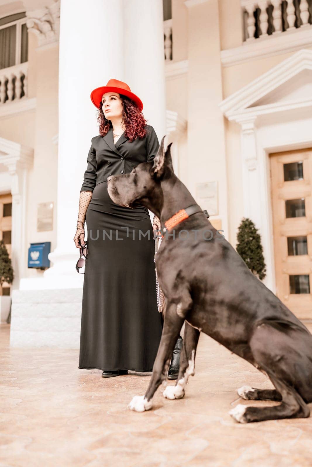 A photo of a woman and her Great Dane walking through a town, taking in the sights and sounds of the urban environment. by Matiunina