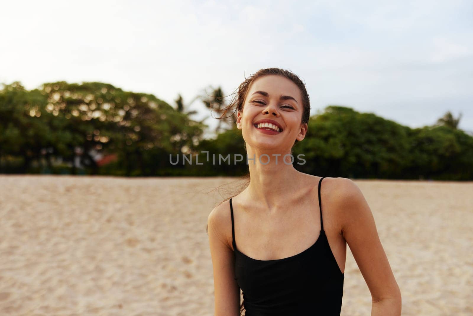 copy-space woman sunset vacation dress ocean young smile sky carefree peaceful lifestyle shore girl sand jean summer sun caucasian sea beach