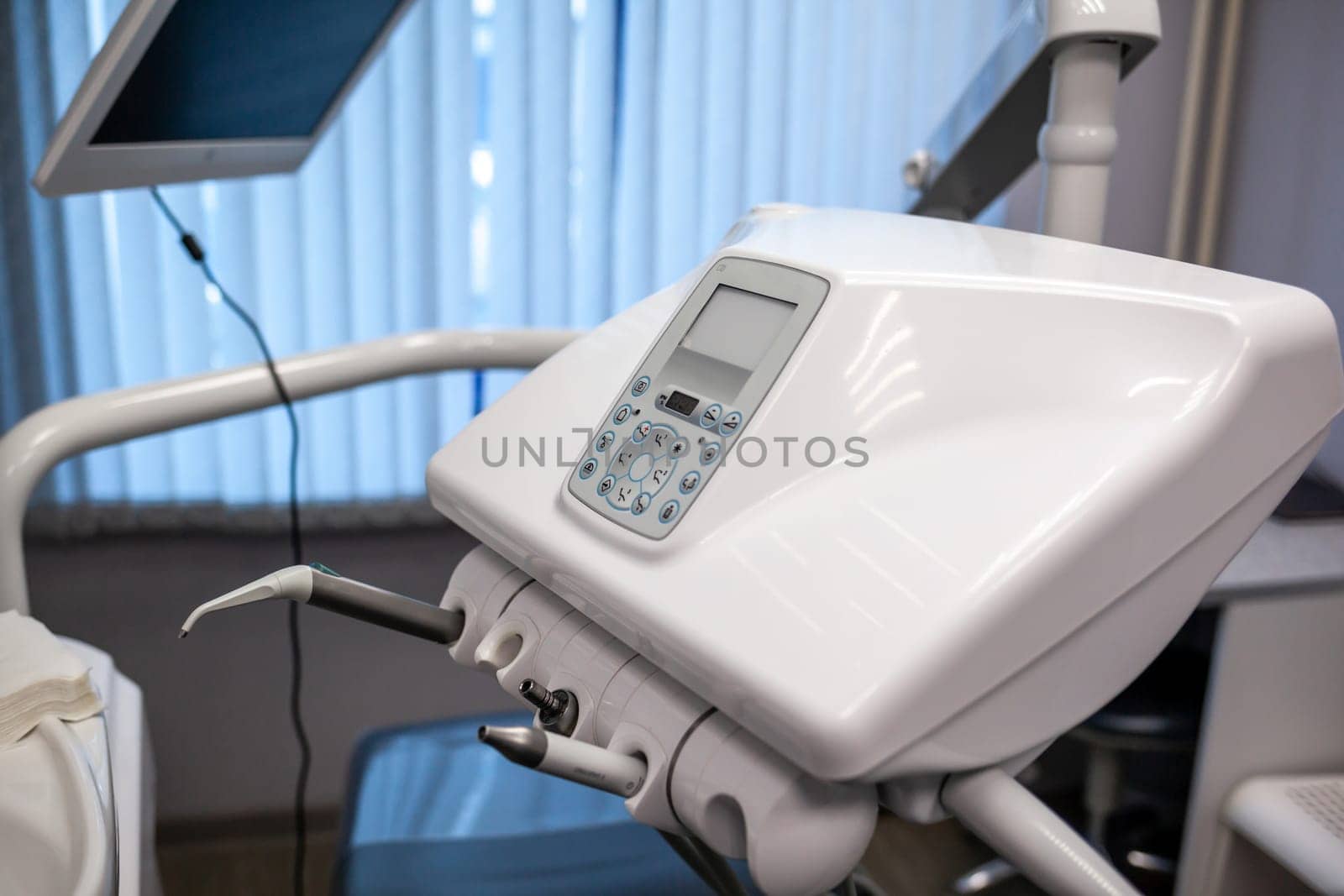 Dental interior office with modern equipment. Modern dental practice. Dental chair and other accessories used by dentists in blue, medic light