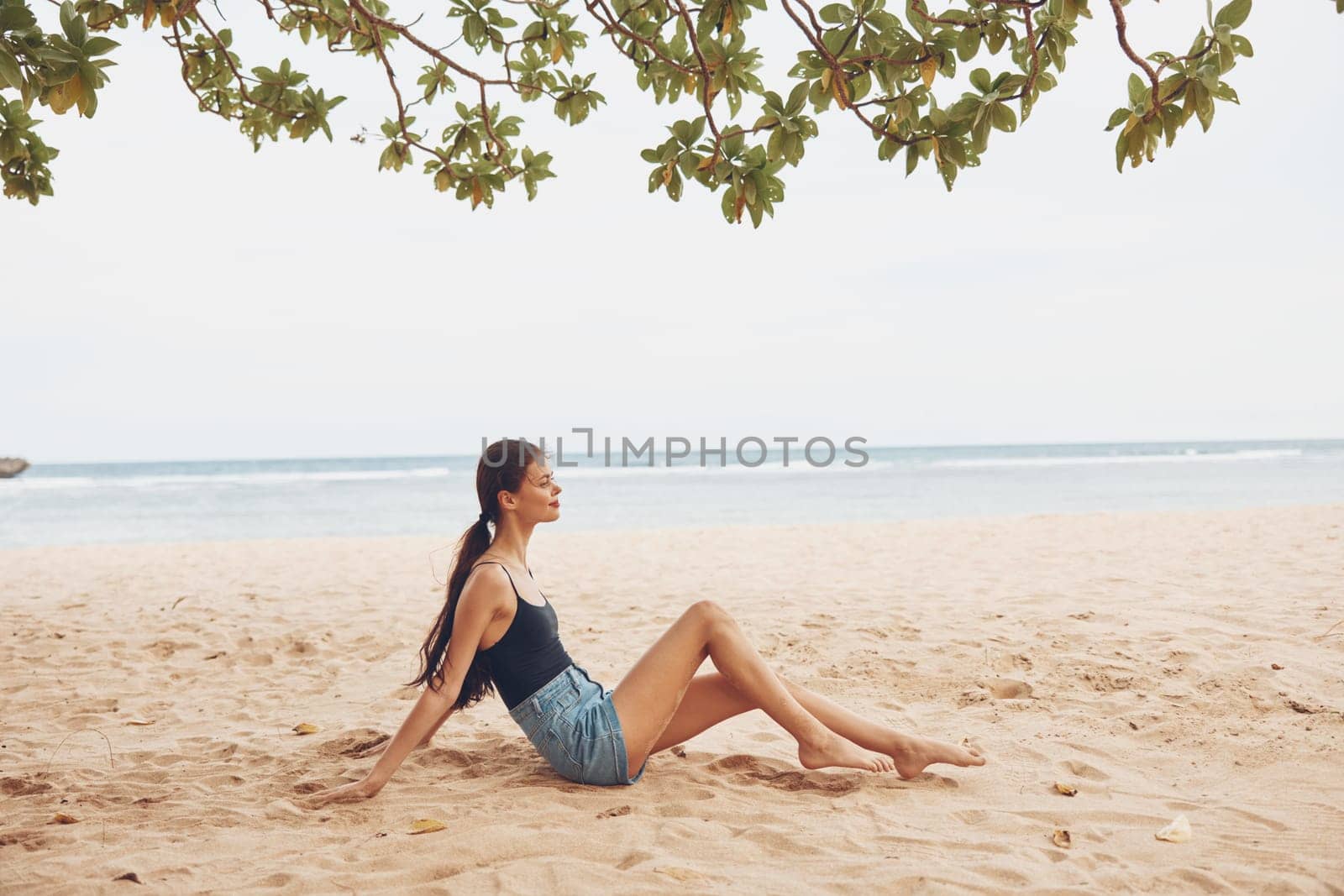 woman alone sand travel beach freedom sexy nature sea sitting vacation smile girl ocean female adult hair relax natural summer fashion