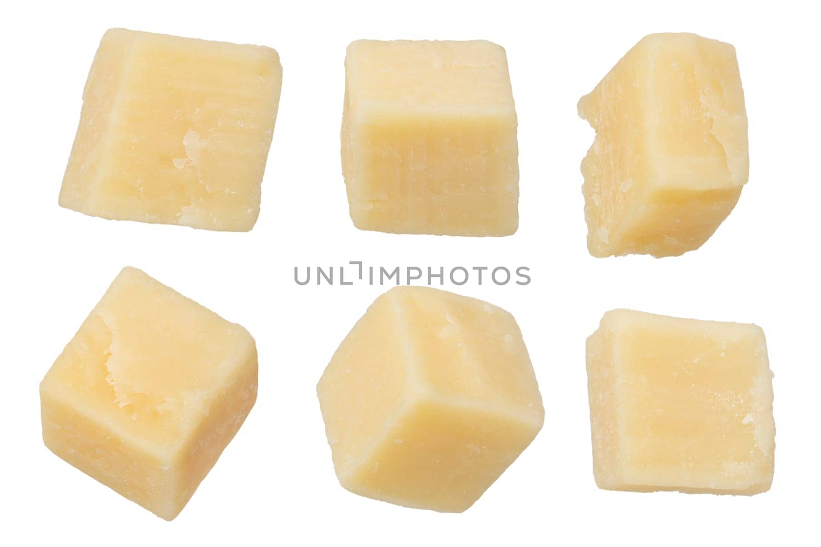 Pieces of hard parmesan cheese isolated on white background. Pieces of square-shaped parmesan on a white background, close-up. Italian variety of hard cheese, long maturation