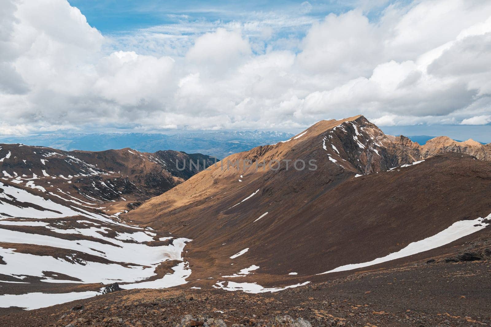 Panoramic beautiful view of the steep snowy rocks ranges on an autumn day in the Pyrenees mountains on a cloudy sky. The concept of southern European national mountain parks. Copyspace by apavlin