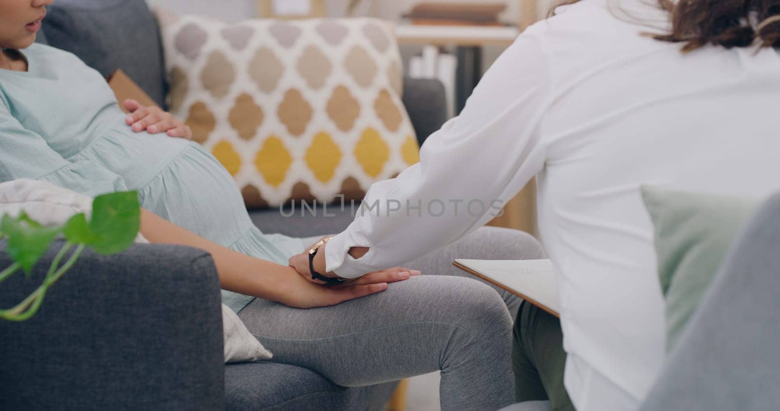 pregnant woman, consulting and nurse on sofa in medical health center. Young female, new mother support and surgery healthcare insurance worker communication with patient or pregnancy treatment care.