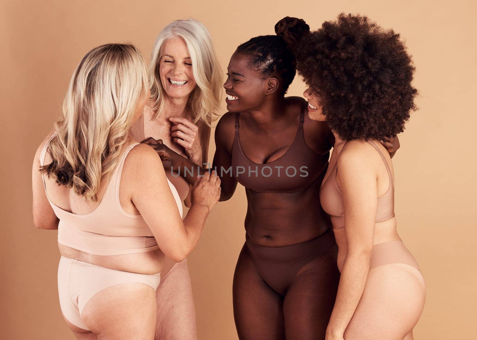 Diversity, women and skincare for body positivity, wellness and talk on brown studio background. Cosmetics, females or multiracial ladies conversation, natural beauty or confident with smile or laugh by YuriArcurs