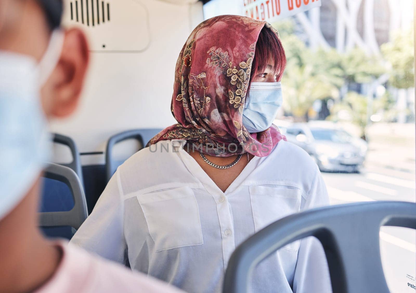 Woman, muslim and bus with mask, covid and healthcare on transport in city, town or metro by window. Islam lady, covid 19 and ppe on transportation for travel, urban adventure or thinking of safety.