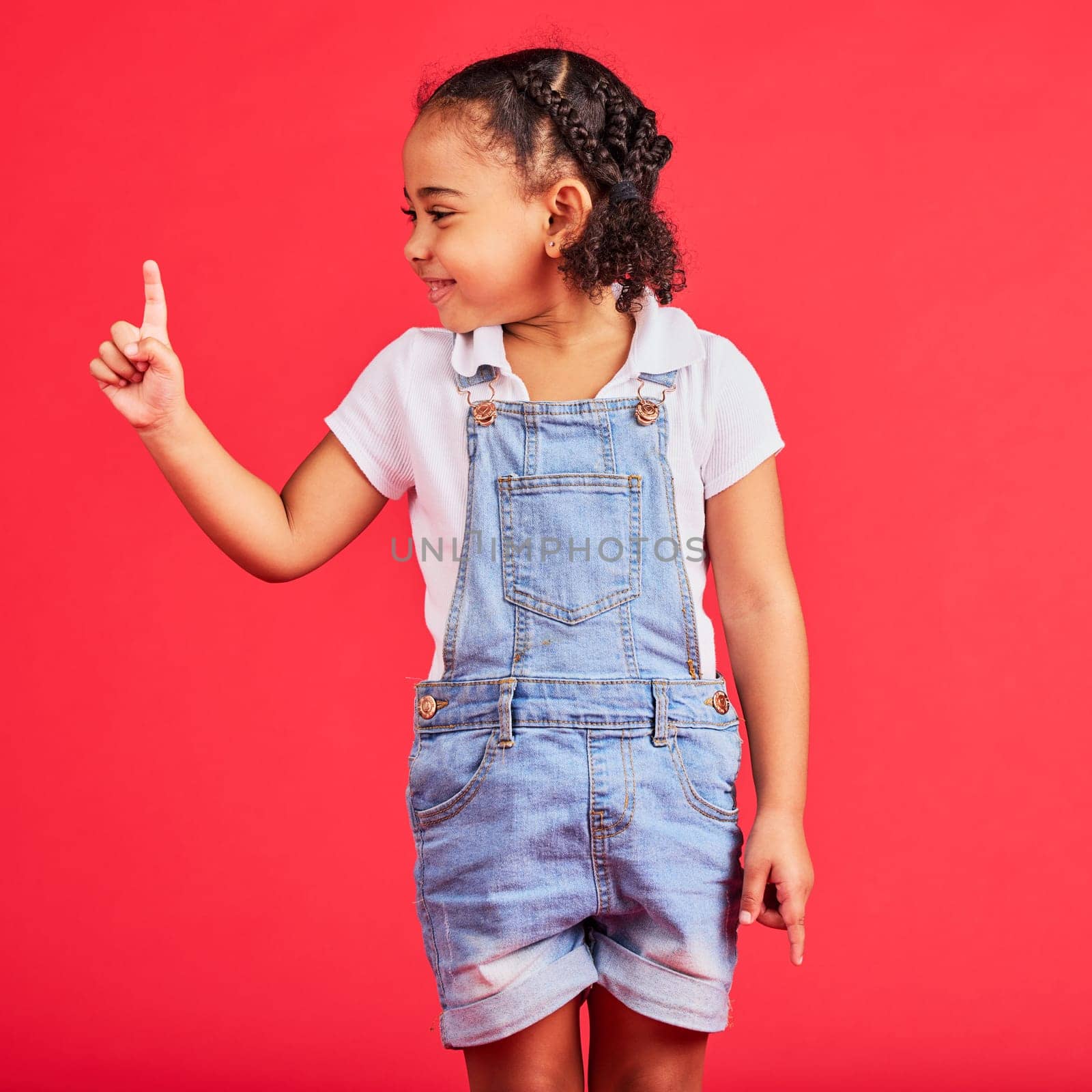Mockup, black girl and finger for space, product placement and kid on studio background. African American female child, young person and brand development for advertising, happiness and cheerful.