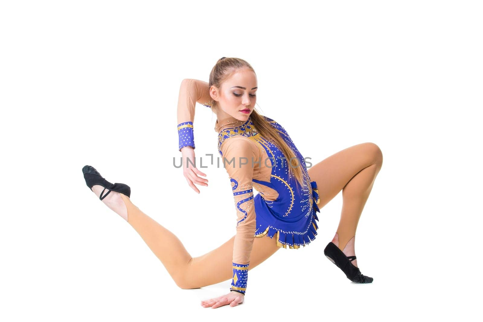 Young girl doing gymnastic exercises isolated. The girl in a blue dancing suit