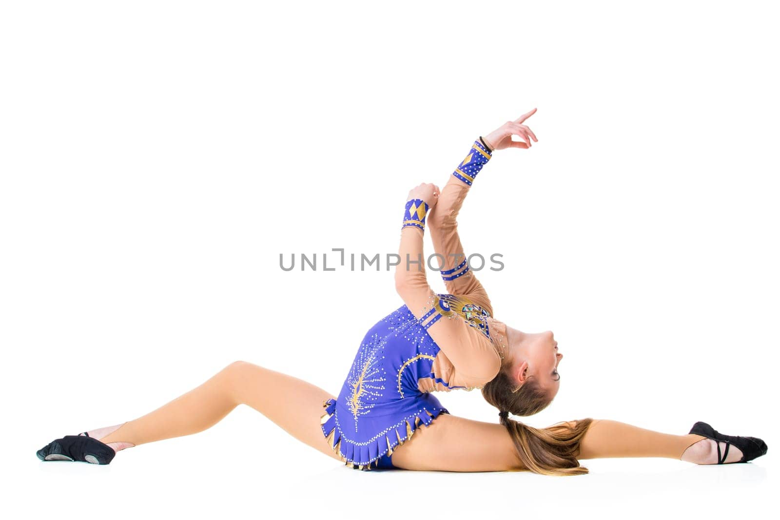 Young girl doing gymnastic exercises isolated. The girl in a blue dancing suit