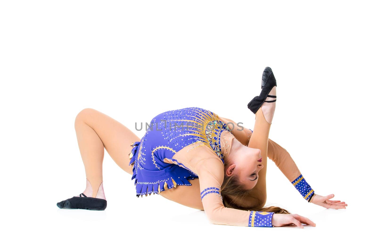 Young girl doing gymnastic exercises isolated. The girl in a blue dancing suit