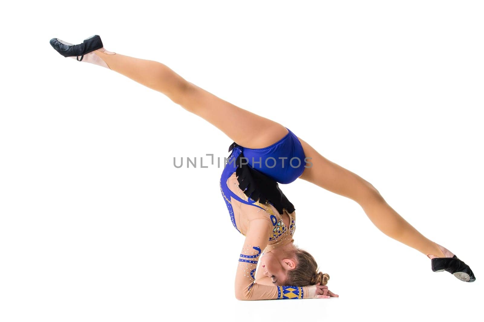 Young gymnast on a white background. Sporting exercises. Aerobics. Flexibility. Plastic study. Twine