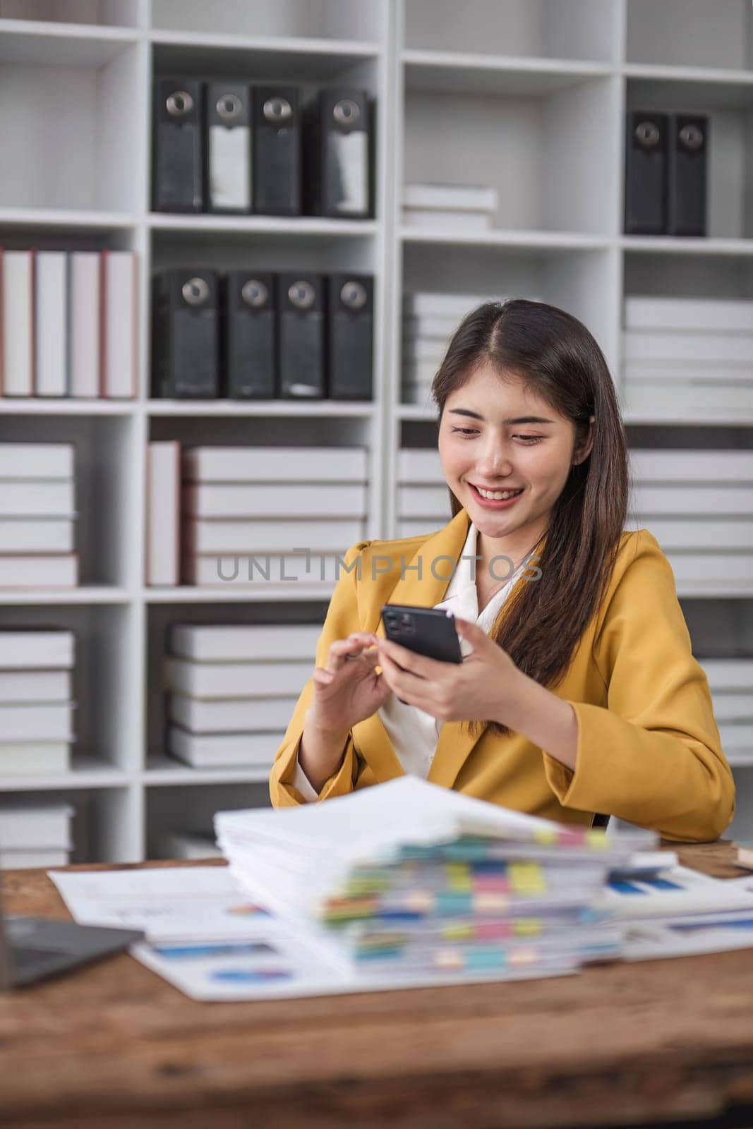 Portrait smile beautiful business asian designer woman with yellow suit working office desk using phone computer. Small business employee freelance online sme marketing e-commerce telemarketing