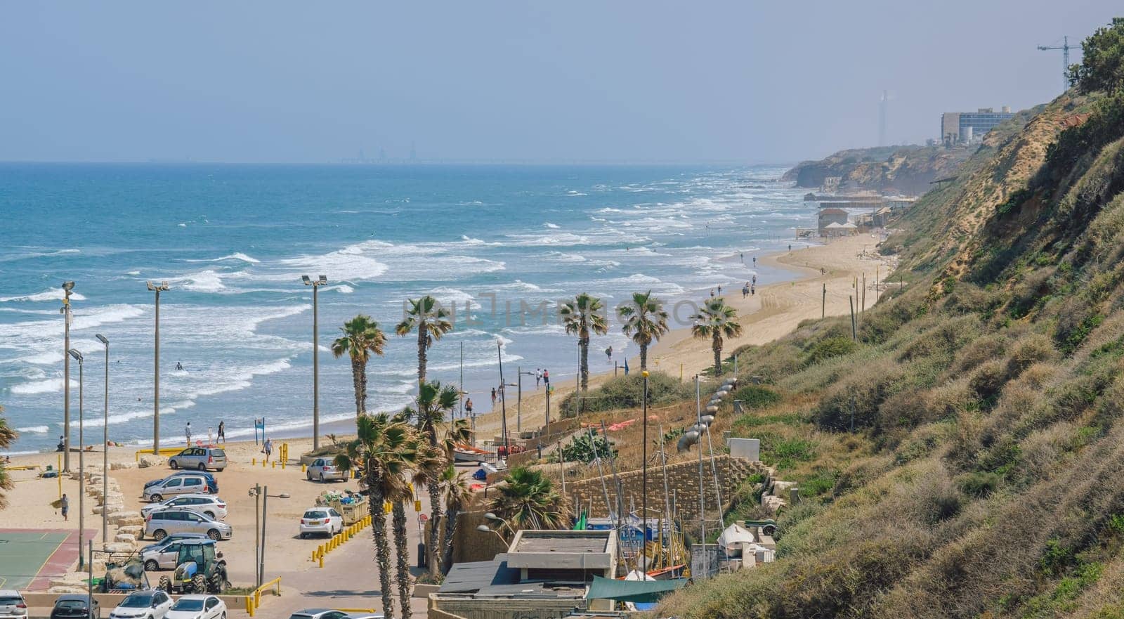 Embankment. Netanya, Israel. May 23, 2023. Palms on the beach in Netanya tropical city on the Mediterranean coast