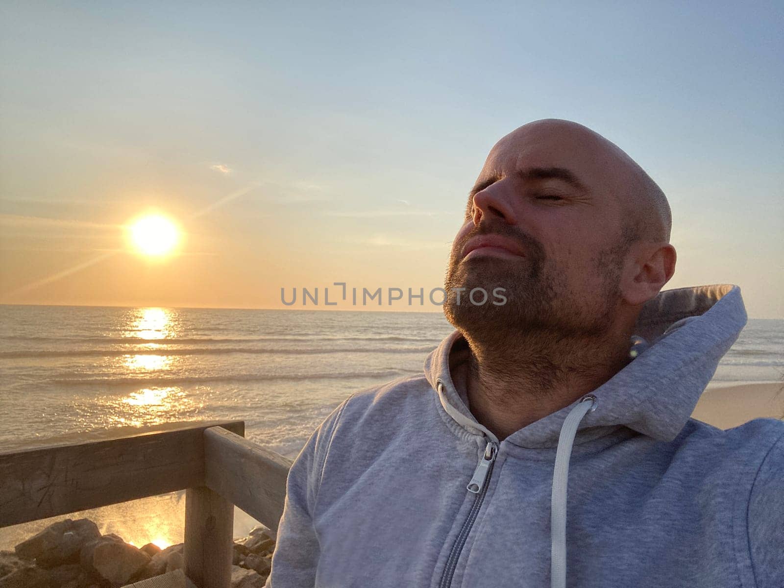 Profile of a of man breathing deep fresh air at sunset by papatonic