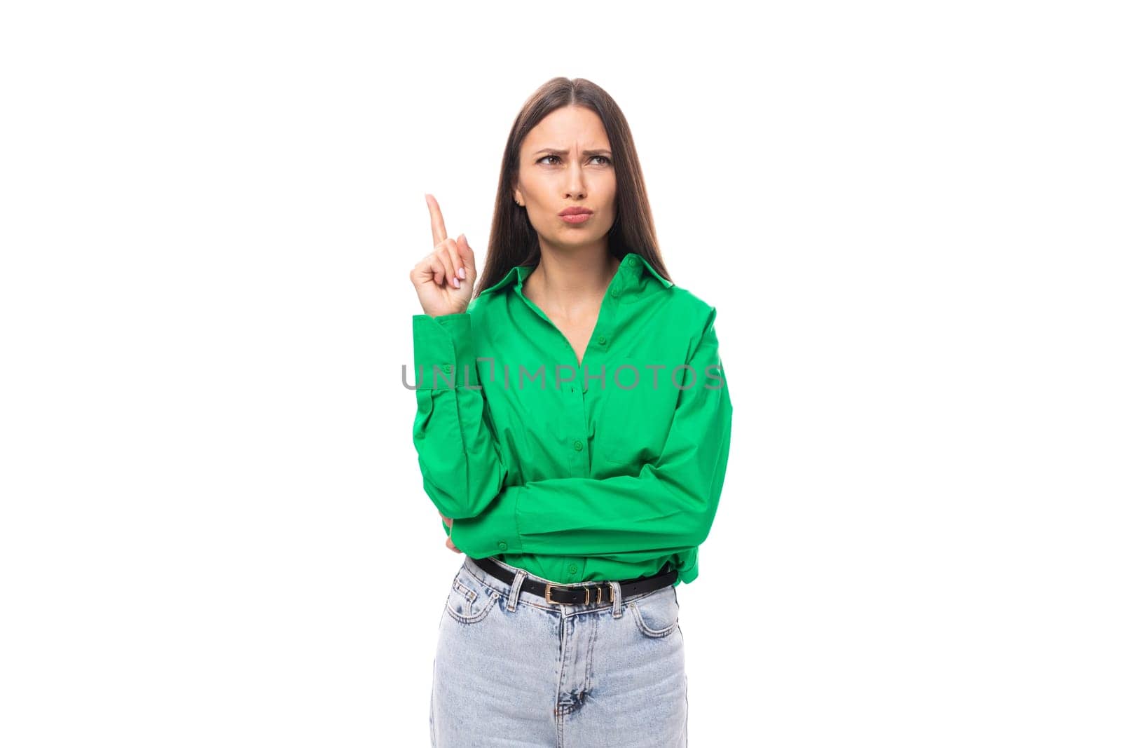 portrait of a smart pensive slim cute brown-eyed brunette woman dressed in a green shirt smiling on a white background with copy space by TRMK