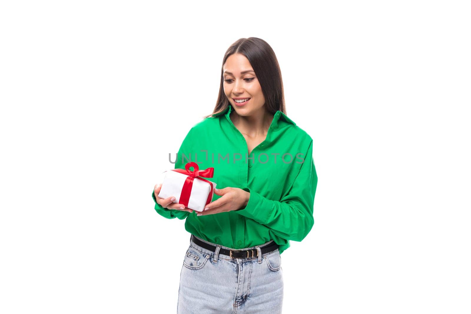 portrait of a happy slim cute brown-eyed brunette woman dressed in a green shirt who received a birthday present.