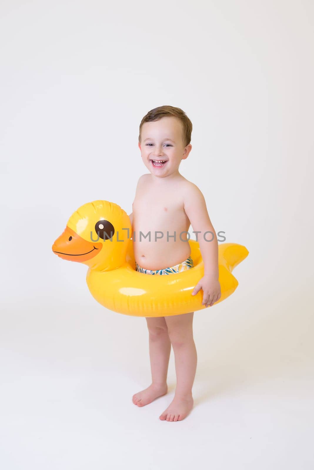 adorable boy with a float on a white background by jcdiazhidalgo