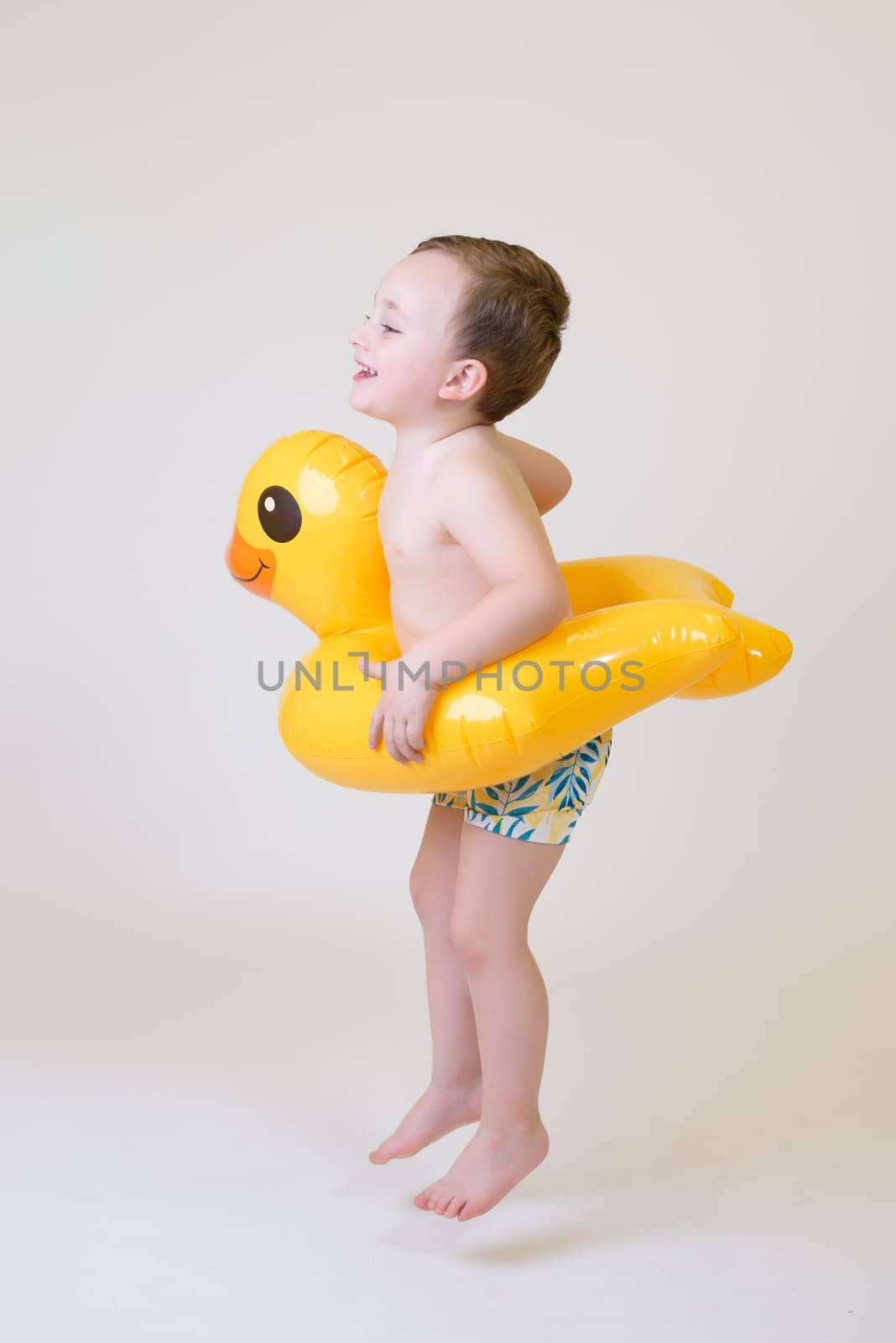 adorable boy with a float on a white background. Summer Vacation..