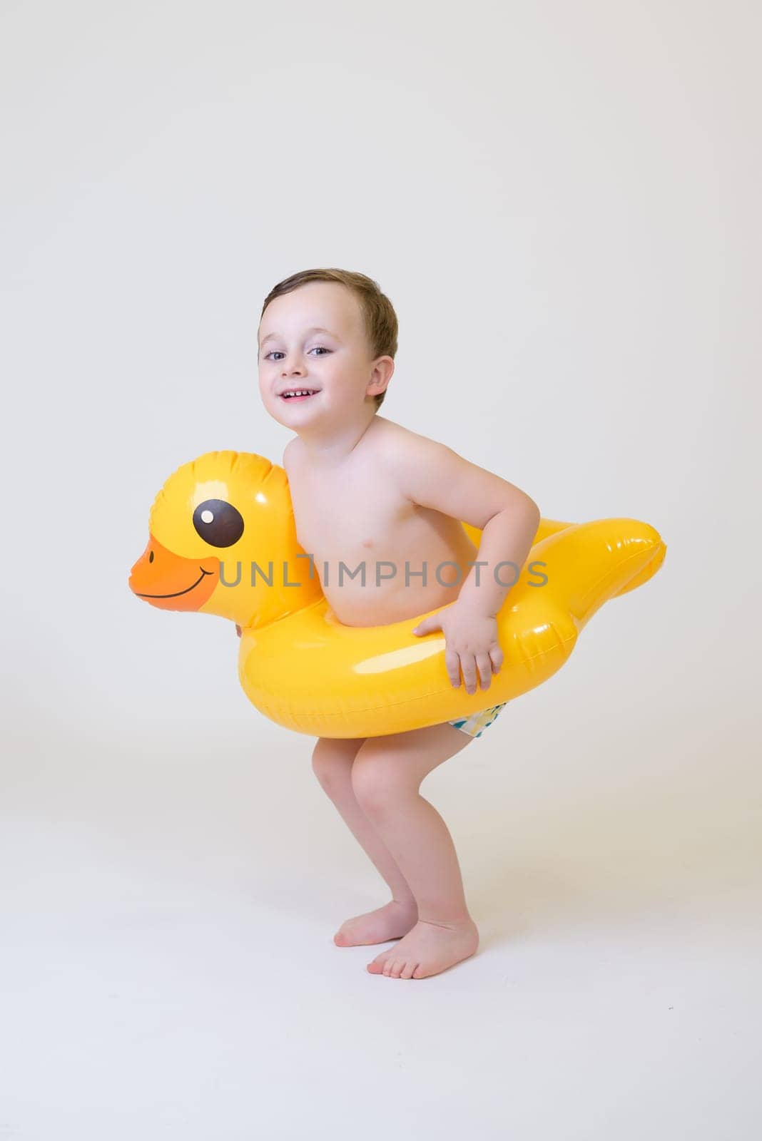 adorable boy with a float on a white background. Summer Vacation by jcdiazhidalgo