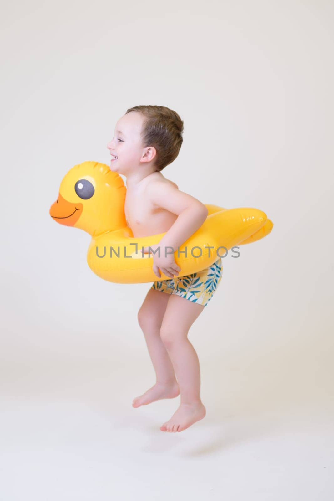 adorable boy with a float on a white background. Summer Vacation