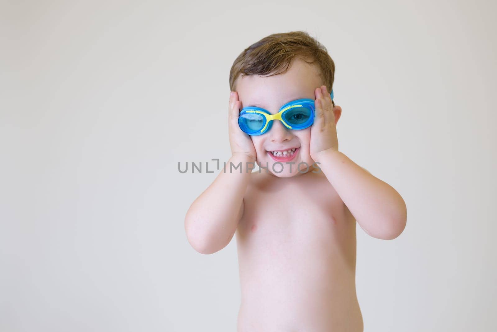 smiling boy with scuba goggles on white background. free space by jcdiazhidalgo