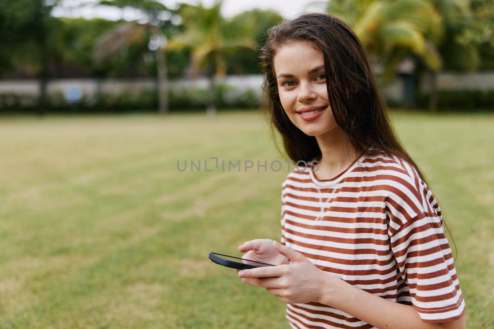 woman palm blogger park lifestyle tree phone grass nature smiling happy caucasian by SHOTPRIME