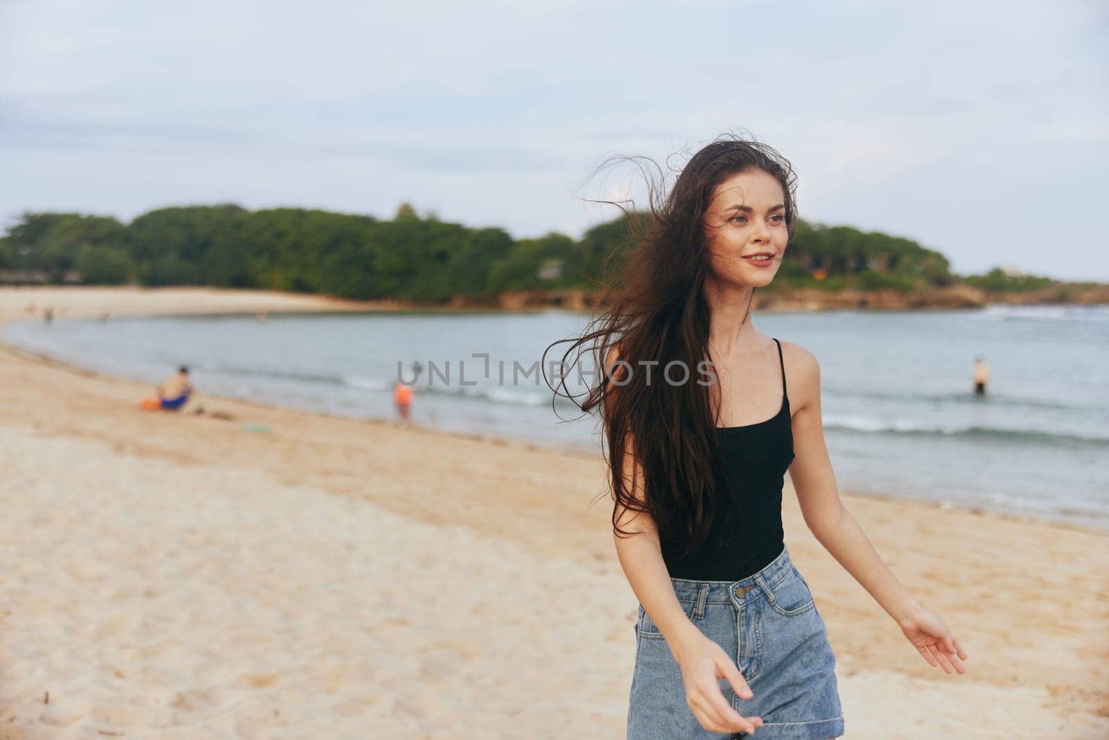 woman walk sunlight person long female beautiful happy tropical ocean sunset beach summer smile sun sea copy-space hair nature lifestyle sand vacation