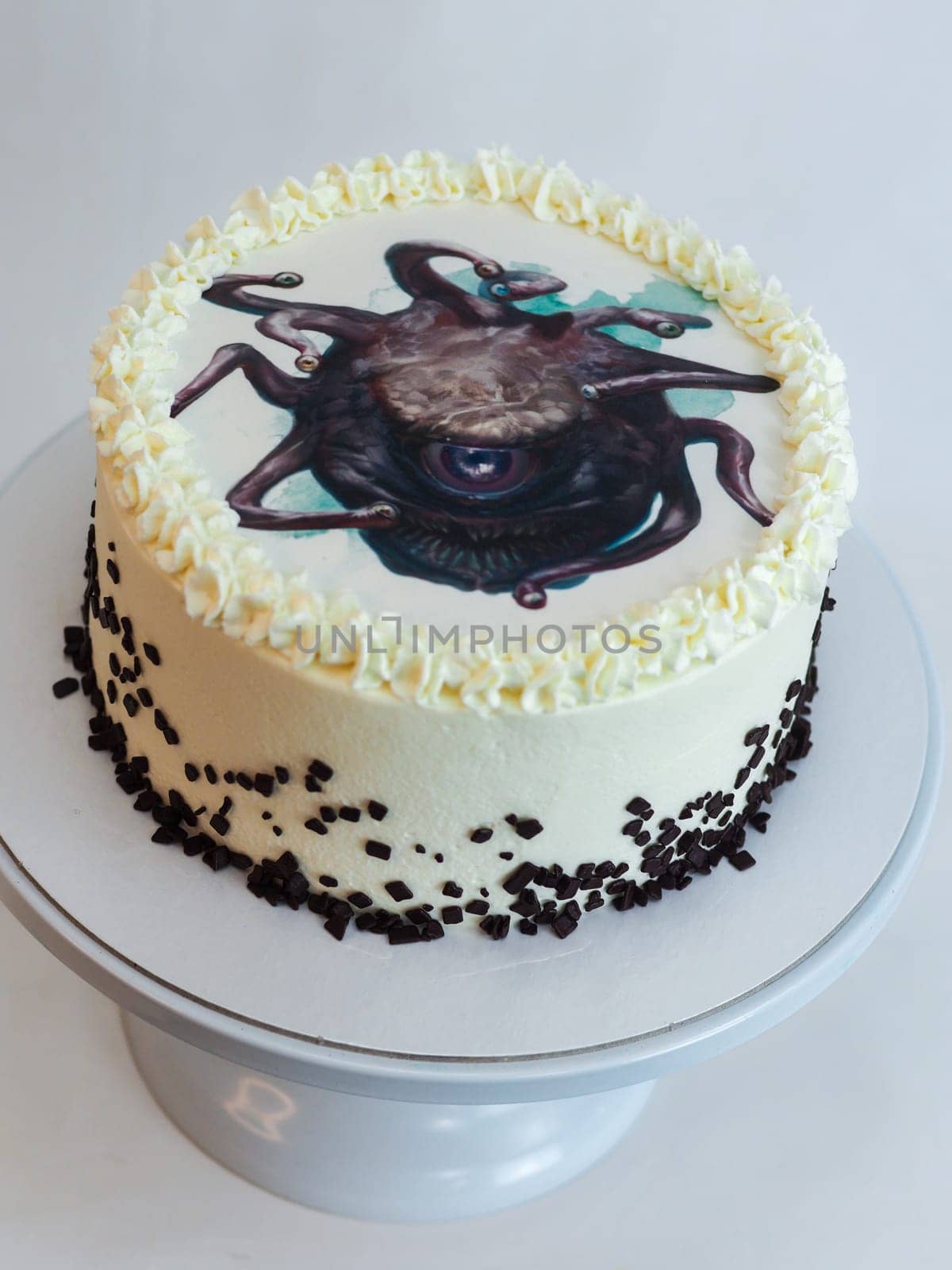 studio isolated shot of frosted white icing cake on white background with monster topping