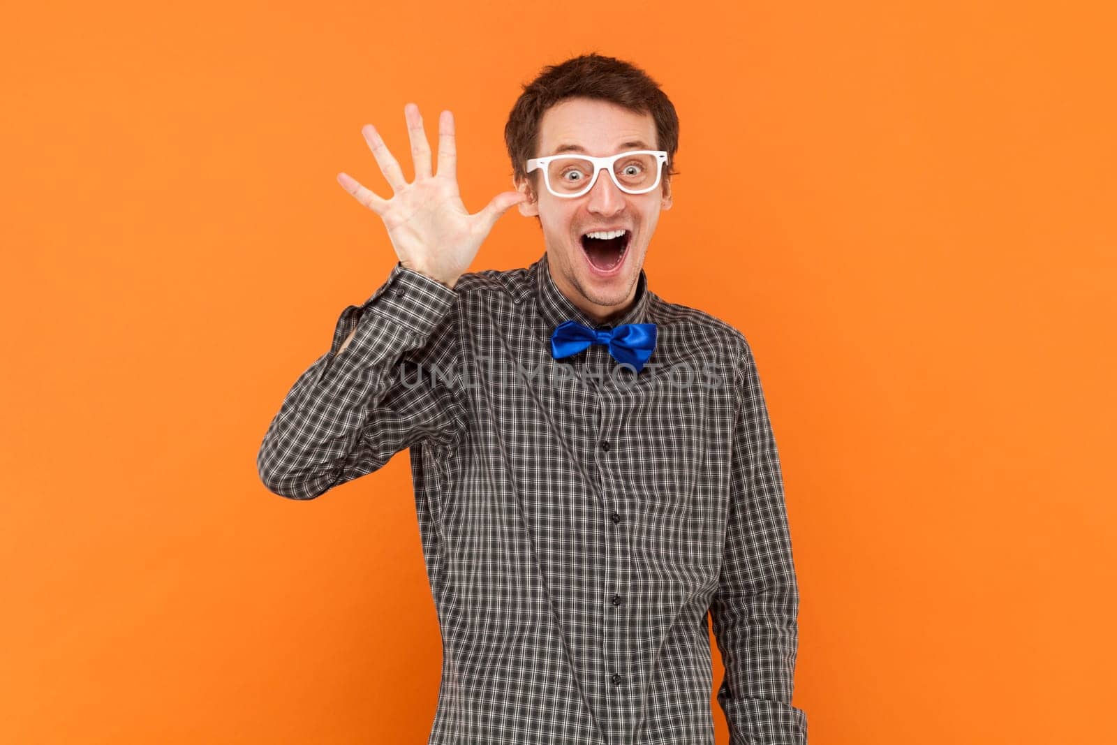 Portrait of funny excited man nerd waving his hand, showing hello or bye gesture. by Khosro1