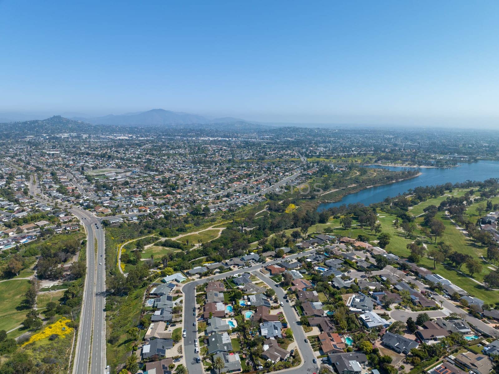 Aerial view of house around Lake Murray reservoir in San Diego, California by Bonandbon
