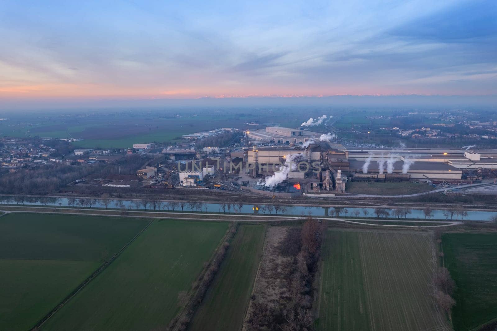 Cremona, Italy - January 2022 Drone aerial view of Arvedi working steel plant at dawn, industrial zone in Spinadesco, Cremona, Lombardy Italy