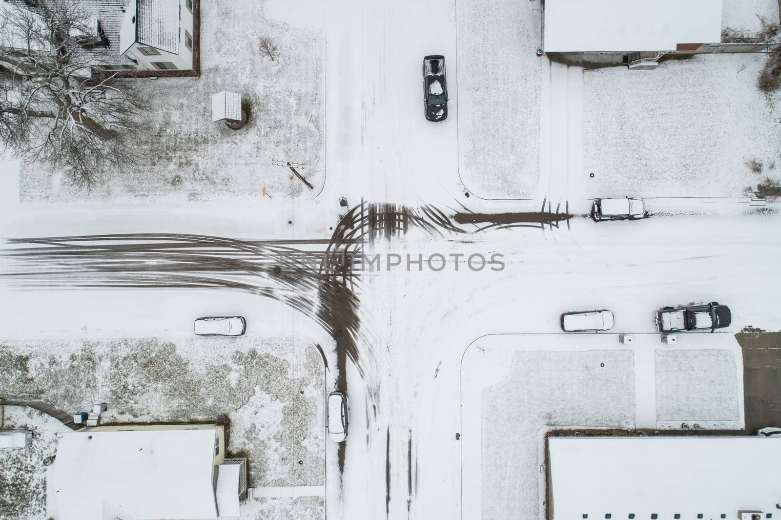 looking down at a snow covered intersection in a city